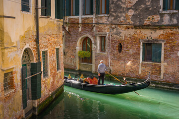 small canal with traditional gondola in Venice in Italy. Architecture and landmark of Venice. Cozy cityscape of Venice. © davide bonaldo