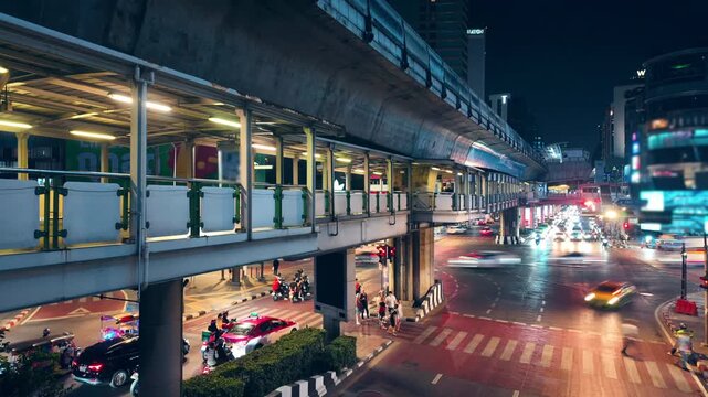 Bangkok night street traffic timelapse on Sukhumvit road, urban city lights with cars and busy intersection in Thailand hyperlapse 4k, bustling Asian megapolis