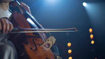 Close-up of Cellist Playing Musical Instrument on Stage with Copy Space © Aliaksei