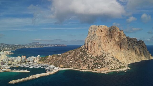 Aerial close view of Penon de Ifach rock and marina harbor in Calpe Spain