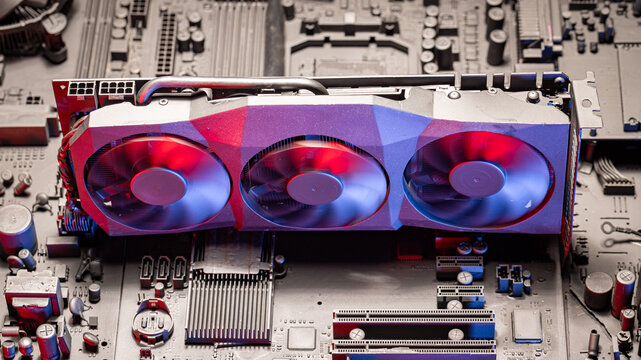 Working motherboards with graphics card, heatsink and fans.