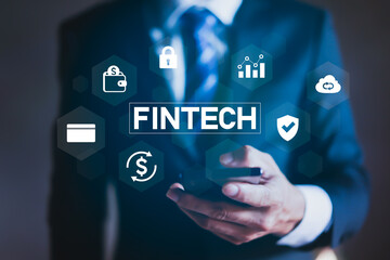 Naklejka premium Businessman using smartphone with digital fintech icons concept