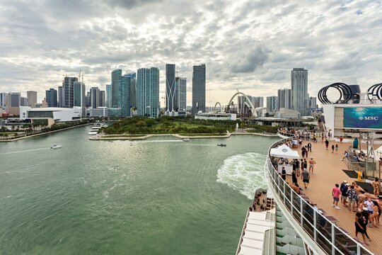 Miami, United States - 16 March 2026: View of Miami's gleaming skyline contrasting with the turquoise waters and a bustling cruise ship deck.