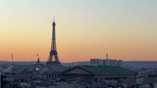 Dawn over Paris. Gentle morning illuminates historic Paris rooftops