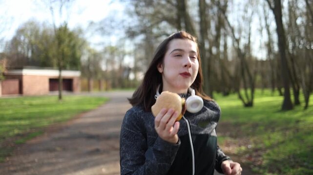 Woman breaks healthy routine during workout choosing fast food instead of discipline showing conflict between fitness goals and cravings lack of control and diet struggle