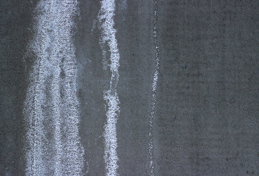 Efflorescence on concrete wall. White salt deposits and water damage texture.