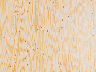 Fototapeta premium Natural light wood surface with wavy vertical grain and scattered dark mineral streaks.