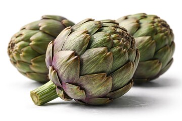 Obraz premium Detailed closeup of whole artichokes capturing intricate surface patterns on a white backdrop for culinary art