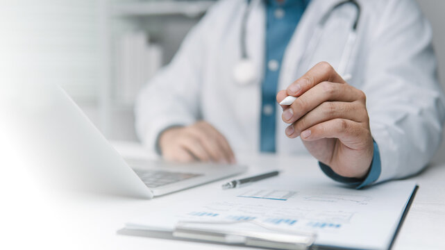 Health care concepts, working on a laptop computer, diagnosis, treatment, and medical services; physicians recording patient data in a hospital examination room, Healthcare and Medical Background