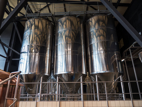 Brewery fermentation tanks, stainless steel vessels, beer production facility.