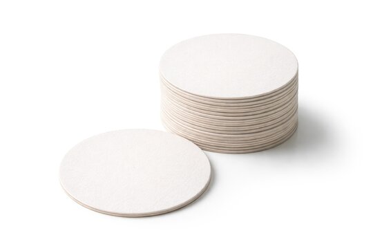 Blank round beer coaster mockup pile on white background offering copy space
