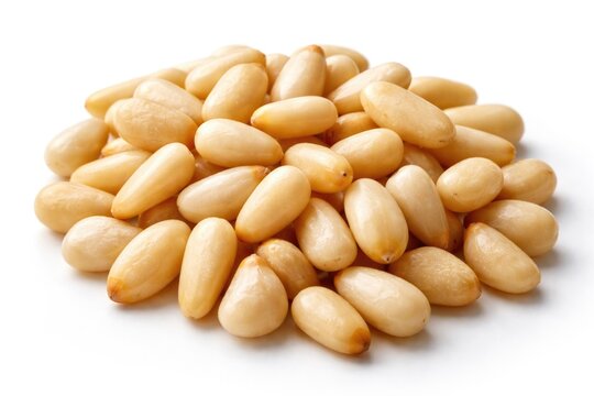Isolated pine nuts captured up close on clean white surface