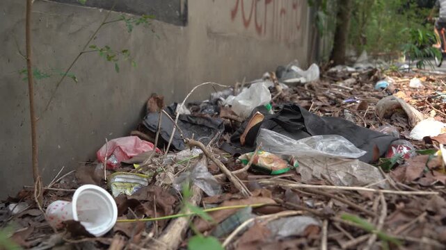 A Pile Of Garbage On The Ground Next To A Wall