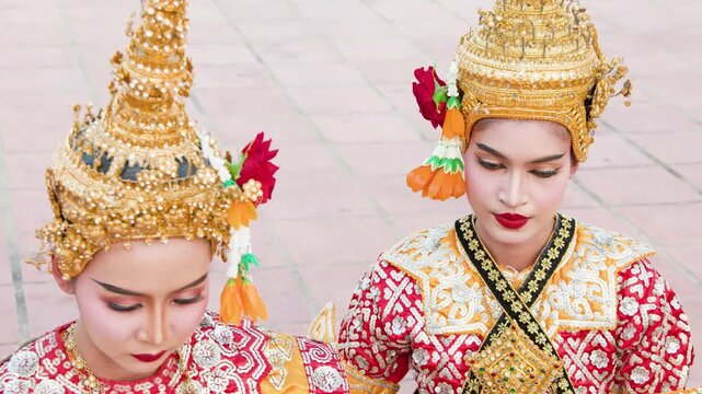 Two Thai Khon Dancers in Traditional Gold Headdresses and Costumes