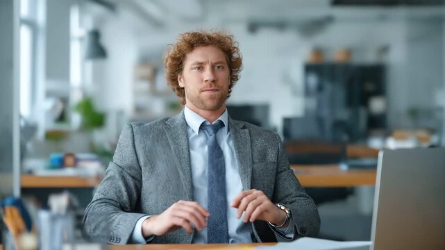 Businessman at desk dodging american football flying towards his face