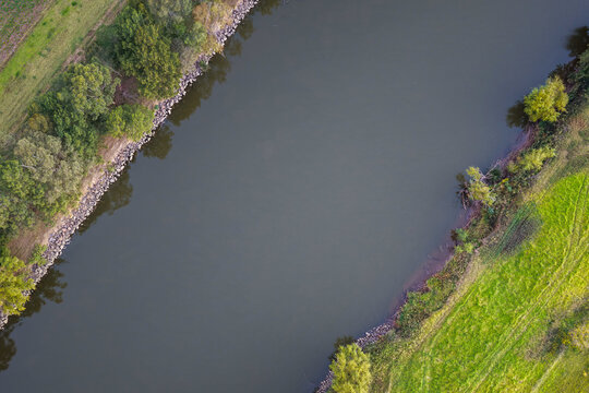 Aerial downward view of Morpeth River in New South Wales, Australia showing surrounding vegetation along river bank. 