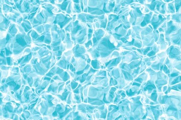 Obraz premium Clear, rippling water in a swimming pool reflecting sunlight, creating a dynamic pattern of light and shadow on the blue surface.