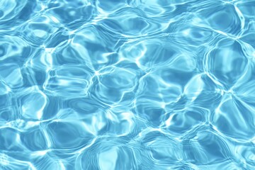 Obraz premium Clear blue water surface with gentle ripples reflecting light, creating a soothing and refreshing pattern.
