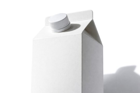 Low angle shot of white milk carton with cap and its shadow on white