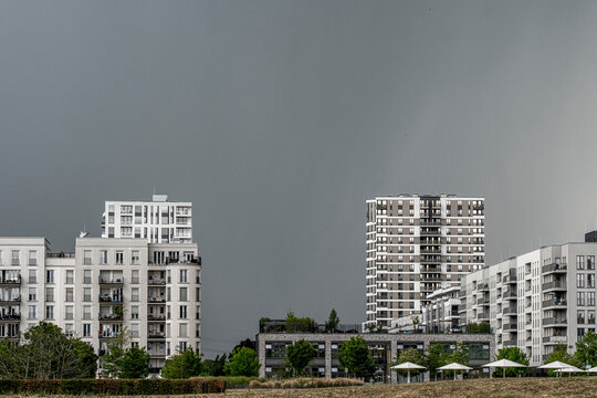 Modern apartments architecture in Frankfurt near Europagarten Germany residential skyline urban clouds and development shaping a contemporary housing district under moody sky