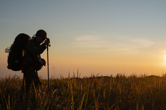 Hiker conquering sunset trails nature landscape outdoor adventure serene environment captivating viewpoint