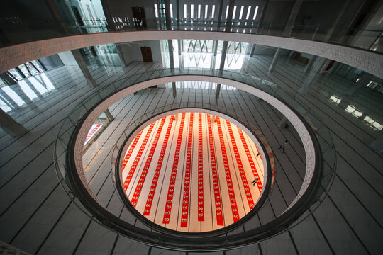 View of the Baitul Mukarram National Mosque interior with rows of red prayer mats, Dhaka, Dhaka Division, Bangladesh.