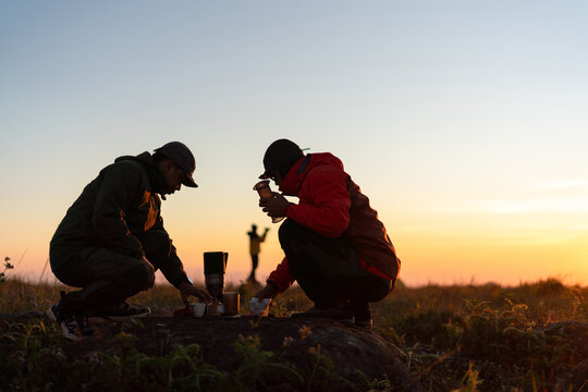 Camping adventure cooking together at sunset outdoor nature lifestyle perspective bonding experience
