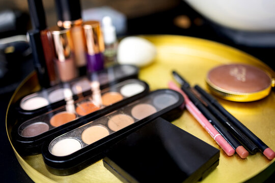 Close up makeup brushes and cosmetics on the table in the beauty salon.