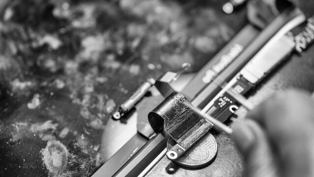 Repairing computer connector in electronics lab with precision tools close-up