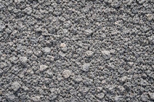 Gray granite crushed gravel with macadam scree texture used in construction base layer
