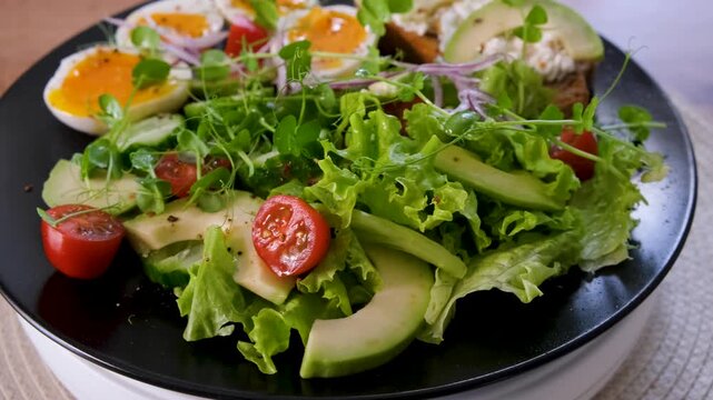Keto Friendly Salad with Eggs and Avocado on Rotating Plate