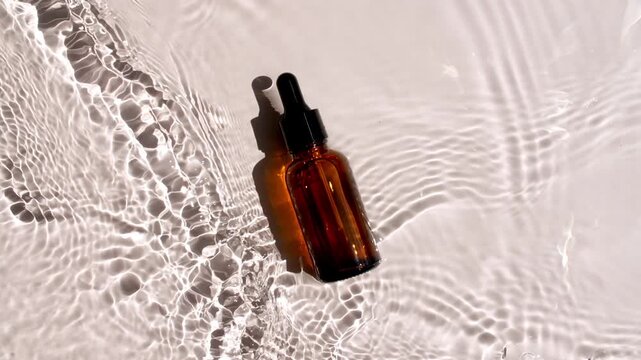 Bottle with a pipette for collagen serum, oil, micellar toner, emulsion on water texture background with splashes. Medical skin care. Packaging for design, advertising of a cosmetic product. 4k 