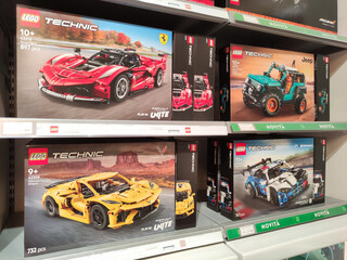 Fototapeta premium Rome, Italy - March 29, 2026: LEGO Technic building sets displayed on a store shelf, featuring Ferrari, Jeep, and sports car models with detailed packaging