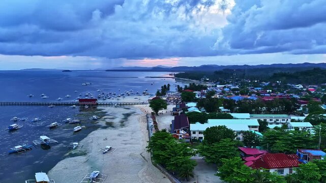 Moody cloudy sky over the coastal village of Poblacion V in Palawan