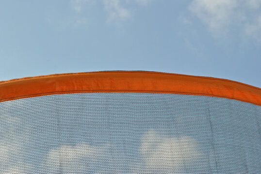 Safety Netting on Trampoline in Close Up against Blue Sky 