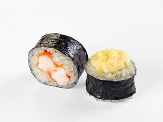 Two maki sushi rolls, one with shrimp filling and one baked with a cheese cap, isolated on a white background. © Andrei Starostin