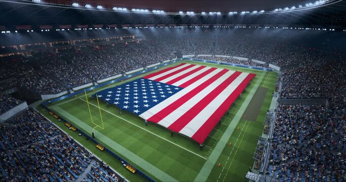 Professional Stadium With American Football Game Championship With Flag of Usa Spread Across the Pitch Before Football Match Start. Cheering Crowds of Fans Surround the Field.  Static Wide Shot.