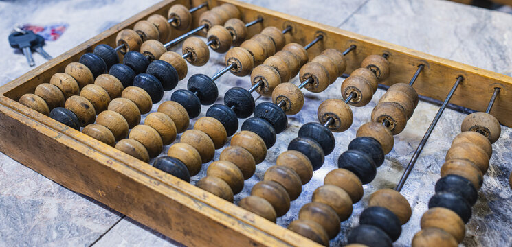 Traditional wooden abacus with black and brown beads