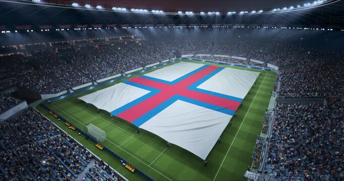 Professional Stadium Soccer Game Championship With Flag of Faroe Islands Spread Across the Pitch Before Football Match Start. Cheering Crowds of Fans Surround the Field. Aerial Elevated Static Wide