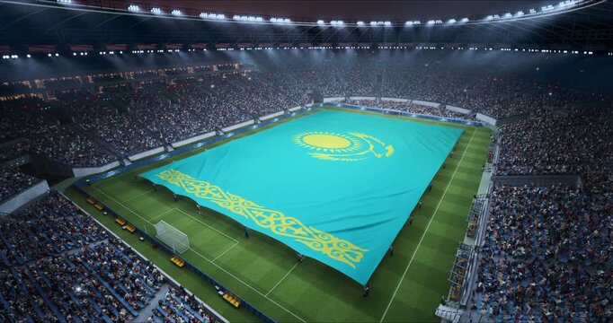 Professional Stadium Soccer Game Championship With Flag of Kazakhstan Spread Across the Pitch Before Football Match Start. Cheering Crowds of Fans Surround the Field. Aerial Elevated Static Wide Shot