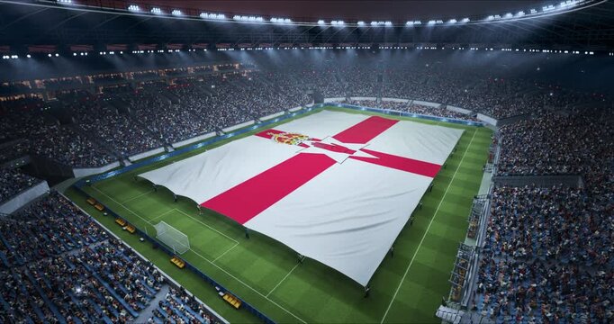 Professional Stadium Soccer Game Championship With Flag of Northern Ireland Spread Across the Pitch Before Football Match Start. Cheering Crowds of Fans Surround the Field. Aerial Static Shot
