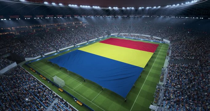 Professional Stadium Soccer Game Championship With Flag of Romania Spread Across the Pitch Before Football Match Start. Cheering Crowds of Fans Surround the Field. Aerial Elevated Static Wide Shot.