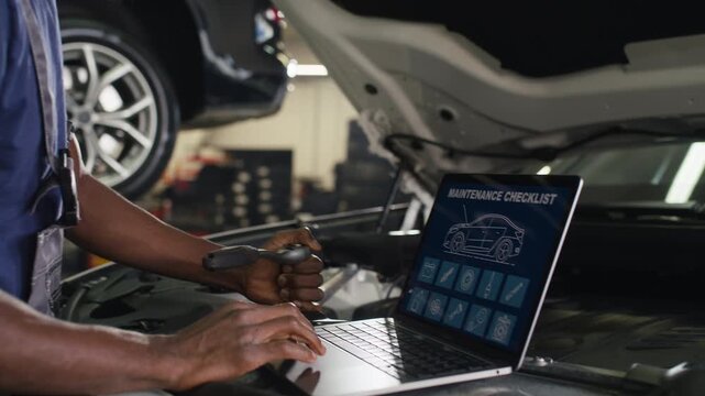 After computer diagnostics, the mechanic manually inspects the engine. Advanced technology and practical skills in a modern car repair shop.