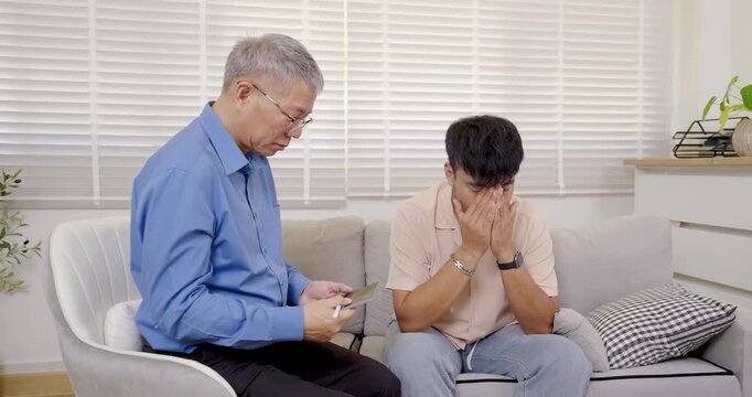Senior asian therapist comforts adult man sitting on sofa crying during therapy session, offering mental health support, advice, emotional healing for depression, stress, personal life problems