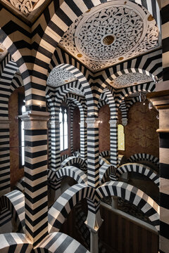 Bologna, Italy - 27 March 2022: View of a room's interior with bold, alternating black and white stripes creating a mesmerizing visual rhythm across its arches and columns.