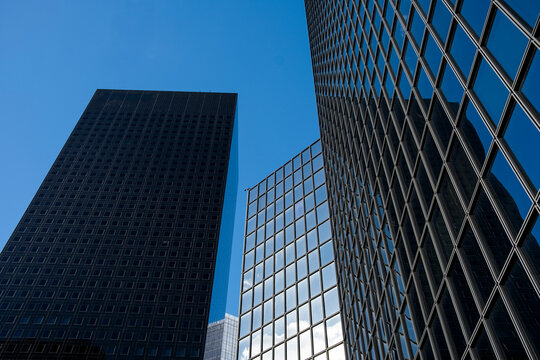 Grid facade architecture skyscraper office glass pattern with strong perspective looking up in Paris La Defense financial district highrise
