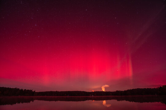 red aurora borealis over the lake