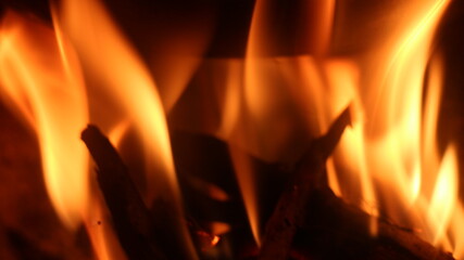 Fototapeta premium Home fireplace with burning wood, blazing fire creates a warm and cozy atmosphere.
