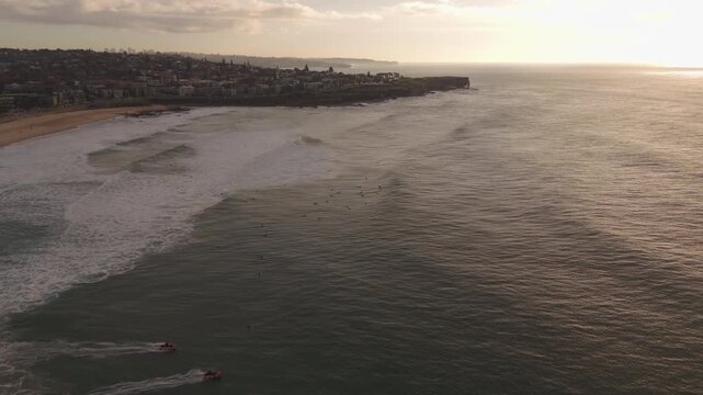 Stunning 59 second aerial footage of Maroubra Beach at sunrise captures two small jetboats heading into the Pacific Ocean while the morning sun casts a golden glow over the rolling surf and Sydney coa