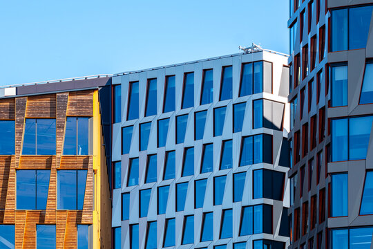 Colorful modern architecture facade in Oslo Norway with pattern windows and minimal skyline plus open space on clear daylight background for designers